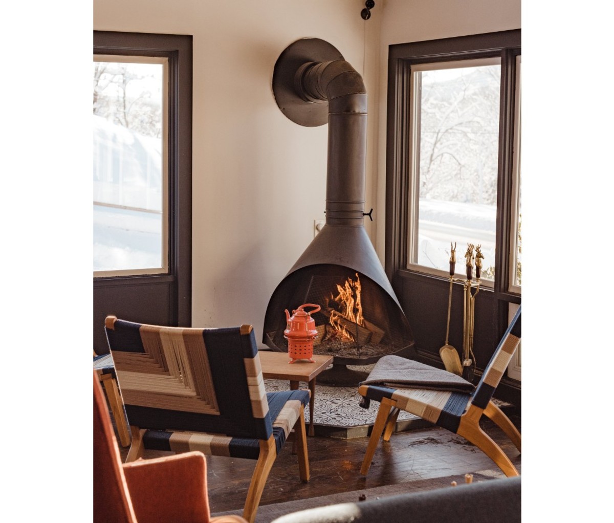 Eastwind Hotel Windham Encapsulates Scandi-Cool in the Catskills 4 Airy space with chairs positioned in front of fireplace