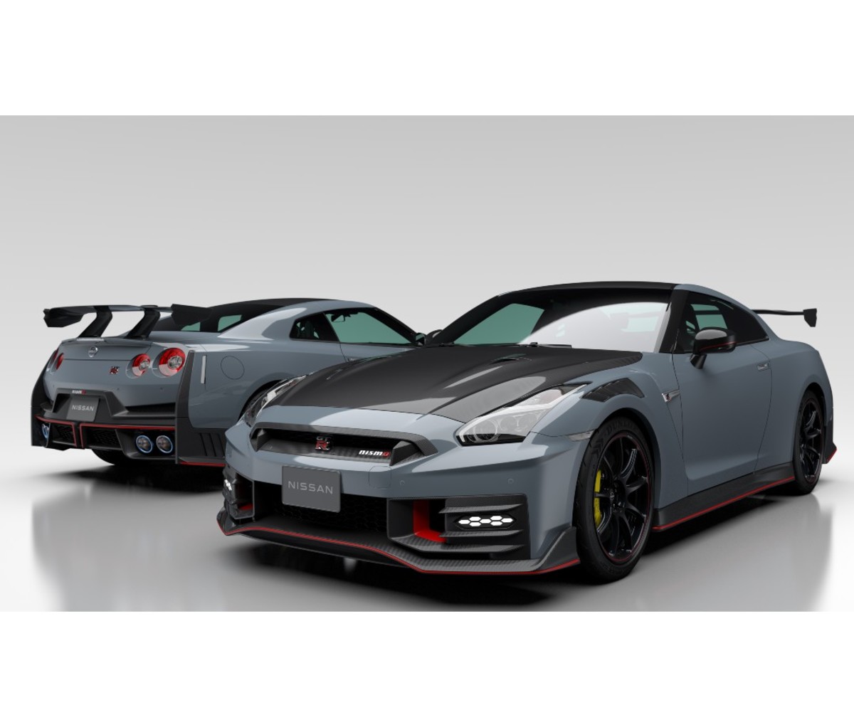 Two silver sports cars in showroom facing different directions
