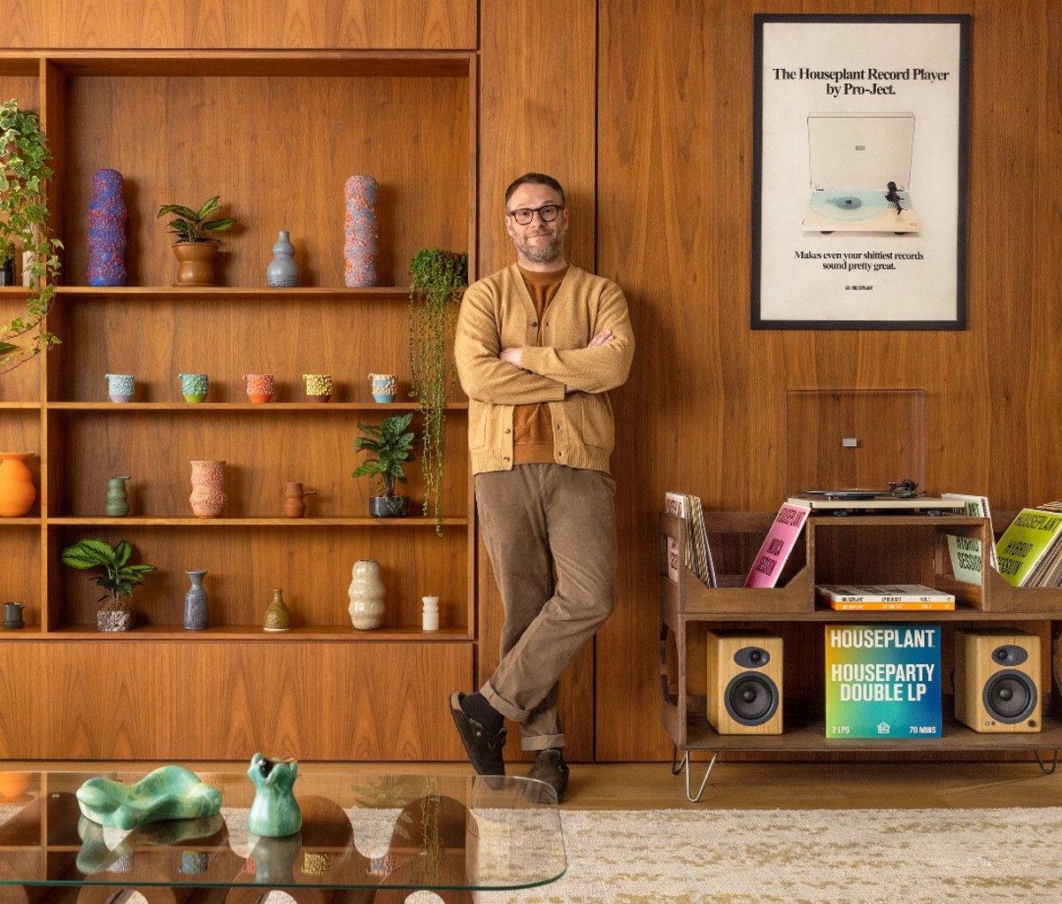 Seth Rogen standing against the wall of his Airbnb creative retreat.