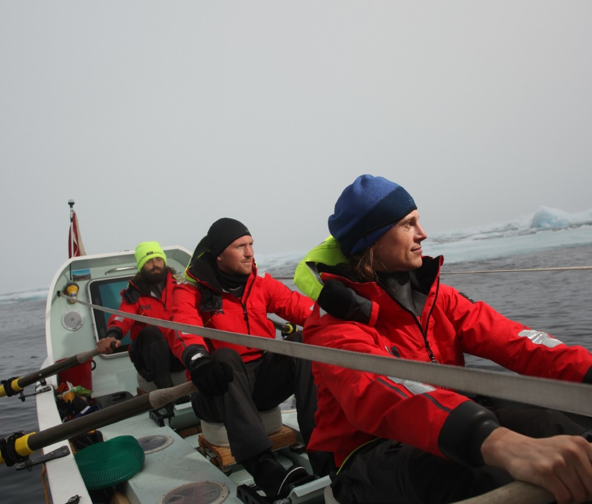 Three crew members rowing across the Southern Ocean