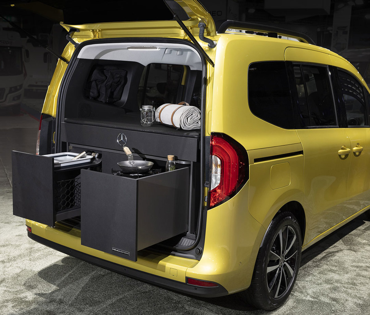 Yellow sprinter van with camping accessories