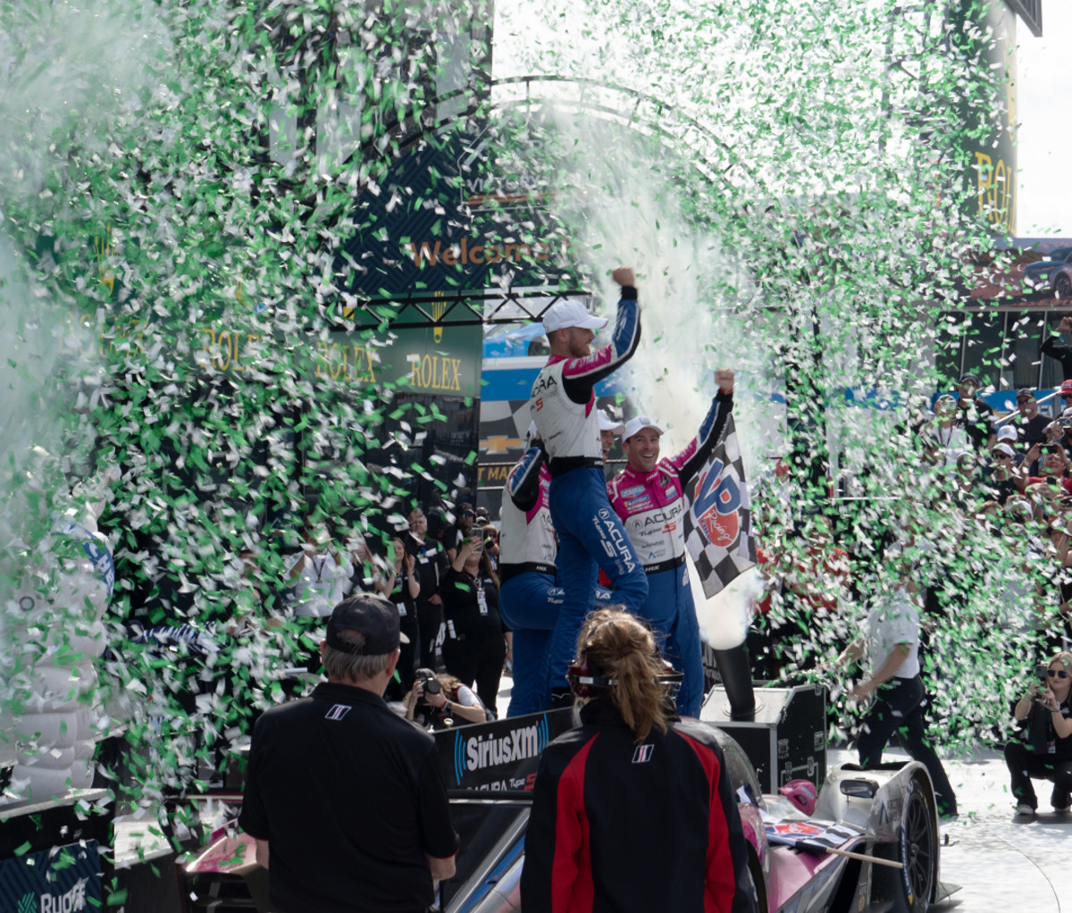 Racecar drivers celebrating a win at the Rolex 24 at Daytona race.