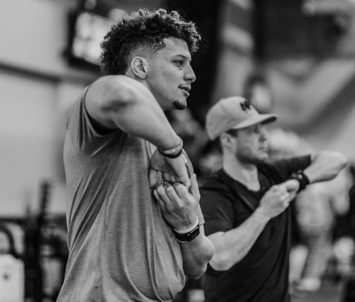 Patrick Mahomes stretching with Bobby Stroupe