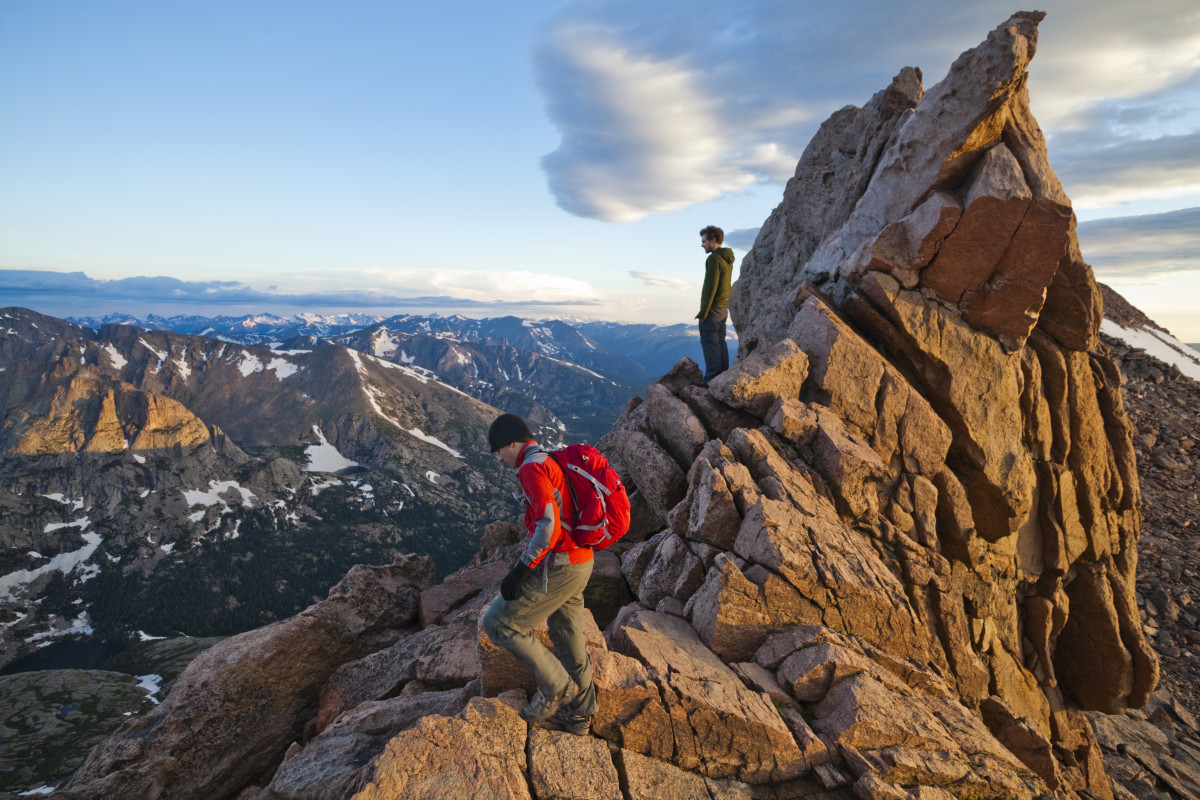 Hikers stand in the Keyhole on Longs Peak, Rocky Mountain National Park, Colorado.